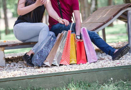 couple winding down on a bench at the local park and enjoying the beautiful weatherの写真素材