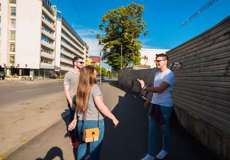 Group of young best friends having fun together walking on town streetの写真素材