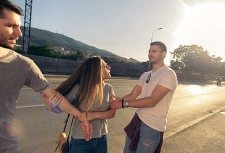 A group of friends walking on the sidewalk in an urban place