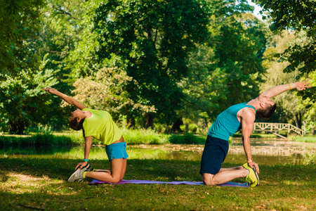 Fitness couple exercising in the parkの写真素材