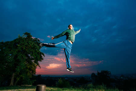 Man performing freerunning jump in park