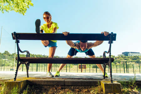 Couple stretching after the run through the park