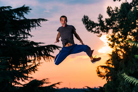 Free runner man exercise parkour outdoor while jumpingの写真素材