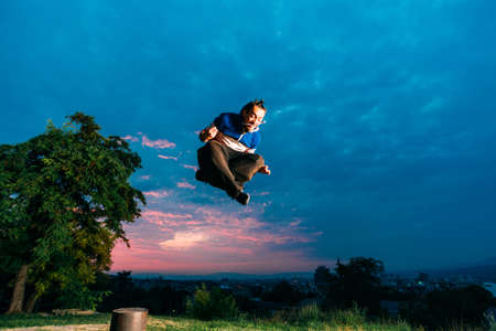 Man performing freerunning jump in park