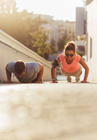 Young couple jogging for fitness in urban environment on a beautiful summer day