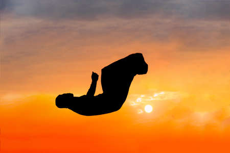 Fitness man doing parkour sport at sunsetの写真素材
