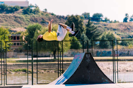 Free runner training parkour on obstacles in skateparkの写真素材