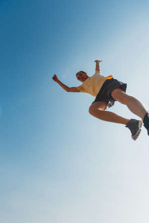 Training day of a young parkour man jumping over obstacles in skateparkの写真素材