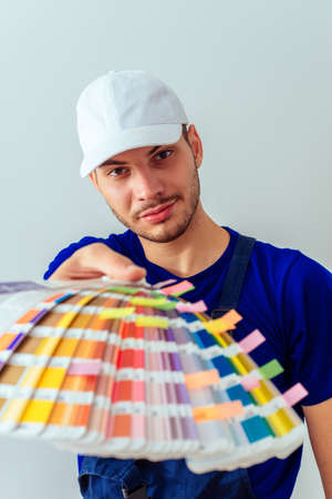 Craftsman with color guide standing in front of the wallの写真素材