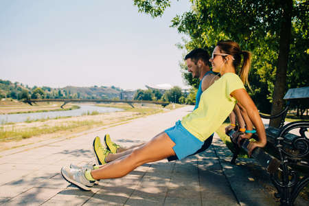 Sportive couple stretching muscles before sport activityの写真素材