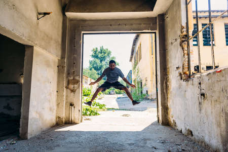 Parkour guy training parkour while jumping outdoors