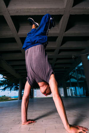 Sportive man training parkour handstand outdoorの写真素材