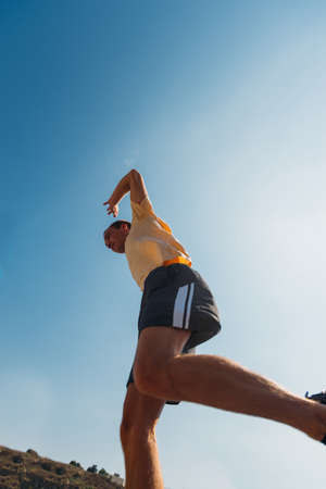Acrobat guy running over obstacles in urban placeの写真素材