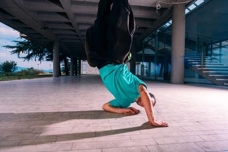 Sportive man doing handstand parkour outdoorの写真素材