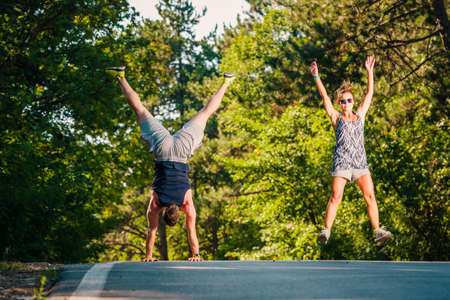Young fit couple on the middle of the road doing exerciseの写真素材