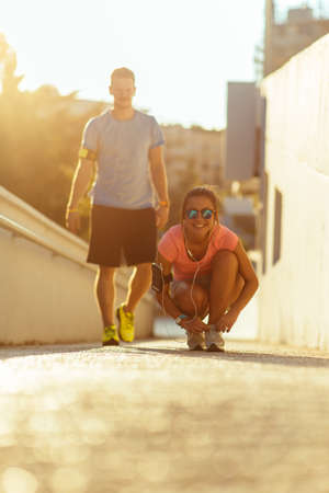 Fit couple prepare to jogging at urban placeの写真素材