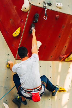 Free climber man climbing up on boulderingの写真素材