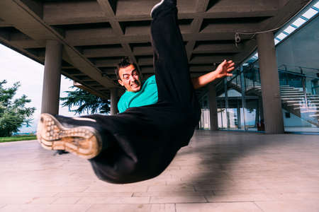 Sportive man doing parkour tricks outdoorの写真素材