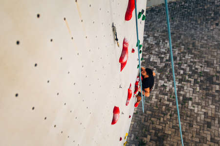 Free climber man climbing up on boulderingの写真素材