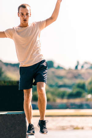 Sportive man exercising while walk on edge outdoorsの写真素材