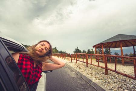 A woman is looking serios while  is driving in some region with small stonesの写真素材