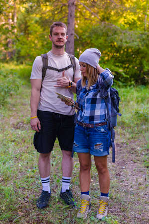 Young couple walking in the forest. Hiking concept in the mountain in summerの写真素材