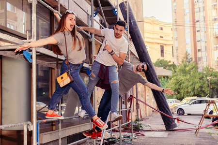 Carefre Friends Hiking On Construction Buildingの写真素材