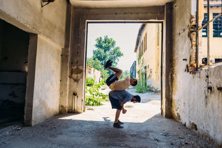 Two sporty friends in action while train together at abandoned factoryの写真素材