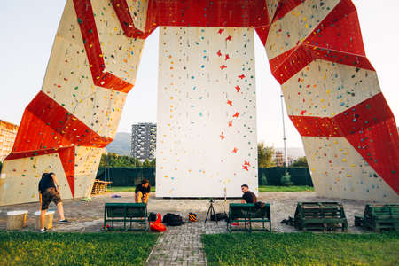 Artificial climbing wall covered with colored holds in an adventure playgroundの写真素材