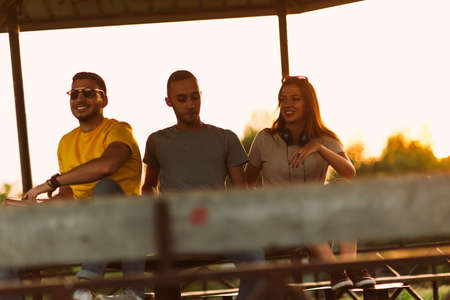 Friends chatting on a benchの写真素材