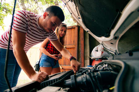 Friends talking about a engine problem.の写真素材