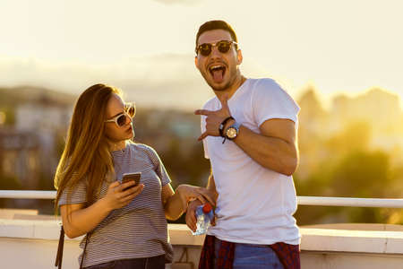Sensual couple enjoying on sunset and having fun on the balconyの写真素材
