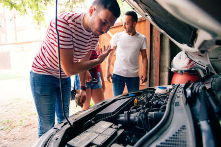 Friends talking about a engine problem.の写真素材