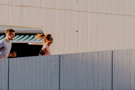 Urban sports healthy couple running through the city