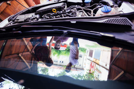 Friends talking about a engine problem.の写真素材