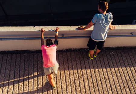 Runners training outise while jogging on sunset