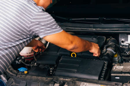 Senior mechanic repairing his car.の写真素材