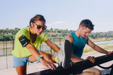 Stretching athlete couple wellness workout fit conceptの写真素材