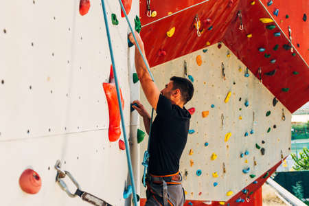 Free climber man climbing up on boulderingの写真素材