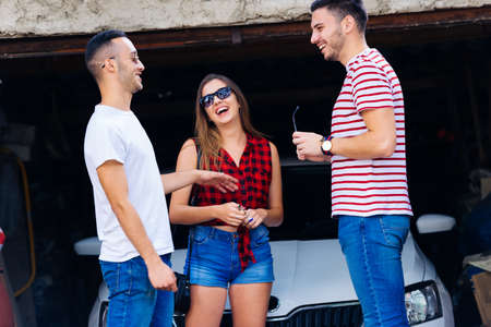 Three frineds talking,laughing,having good timeの写真素材
