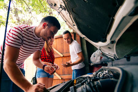 Friends talking about a engine problem.の写真素材