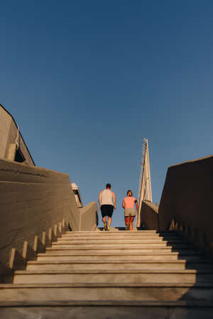 Fitness couple jogging upstairs at urban placeの写真素材