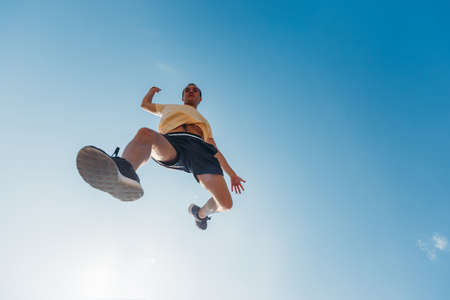 Youung man in air while training parkourの写真素材