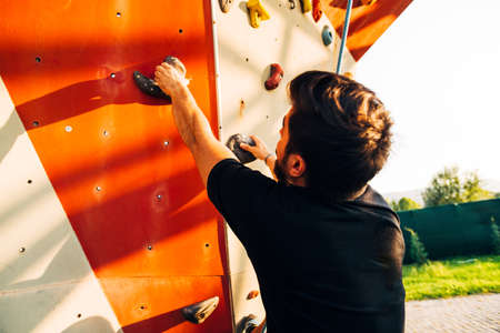 Young man climbing wall rock an extreme sportの写真素材