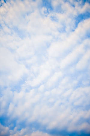 Blue sky background with white cloudsの写真素材