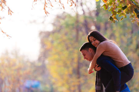 Beautiful girlfriend jumps on her boyfriends back to surprise him.