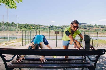 Couple stretching after the run through the parkの写真素材
