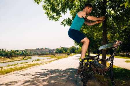 Fit guy stretching and preparing for run in the parkの写真素材