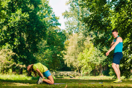 Fitness couple exercising in the parkの写真素材