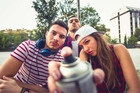 Young and careless people are being serious and spending time togetherat urban placeの写真素材